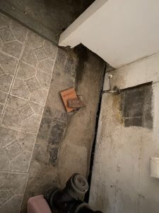 Basement wall with water damage and visible cracks, illustrating the need for waterproofing and repairs.