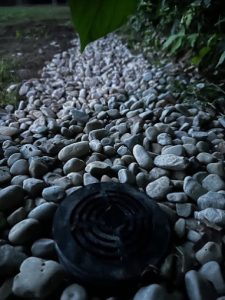 French drain system with gravel and drainage pipe diverting water away from foundation.