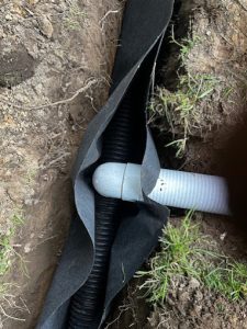 French drain system and drainage solutions protecting foundation from water intrusion.