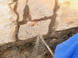 Foundation crack repair and waterproofing demonstration, showing water intrusion and structural damage.